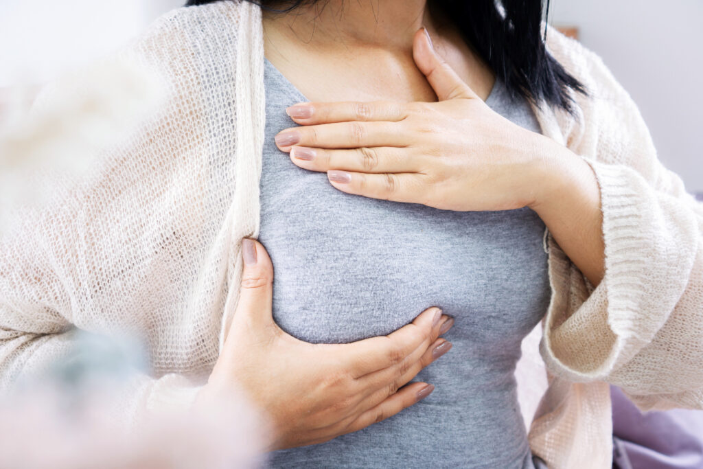 woman hands self breast examination hand checking her breast cancer sign